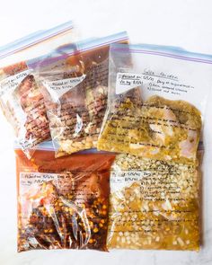 three bags of food sitting on top of a table next to each other in plastic wrappers