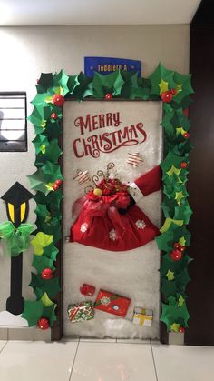 a christmas door decorated with green and red decorations