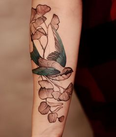 a bird with flowers on its arm