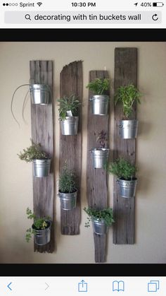 a wall mounted planter made out of wooden planks with plants growing on it