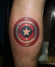 a man's leg with a captain america tattoo on it