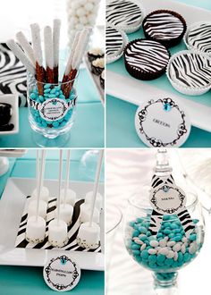 the dessert table is decorated with zebra print and blue candies, white chocolate covered straws, black and white striped lollipops