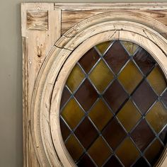 an old wooden door with a stained glass window in the center and wood frame around it