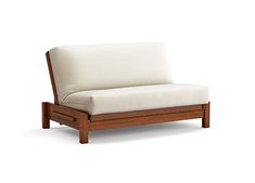 a white couch sitting on top of a wooden frame