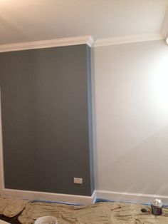 an empty room is being painted with gray paint