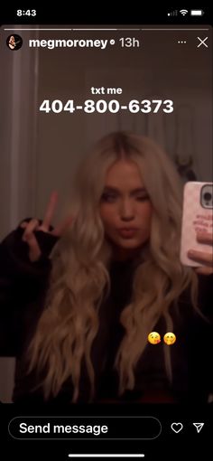 a woman with long blonde hair taking a selfie in front of her cell phone