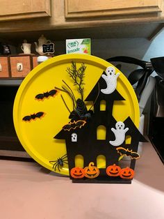 a yellow plate with halloween decorations on it