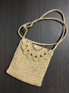 a crocheted purse sitting on top of a wooden table