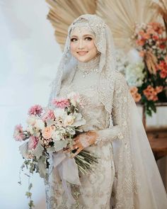 a woman in a wedding dress holding a bouquet