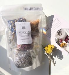 the package is filled with dried flowers and herbs for making an edible flower tea recipe