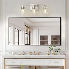 a bathroom vanity with two sinks and a large mirror above it, all in white