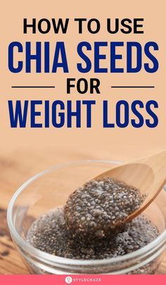 a glass bowl filled with chia seeds on top of a wooden table next to a spoon