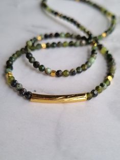 The dainty green jade necklace, adorned with Gold-filled tube, cube beads and faceted jade elements, is perfect for your mother, grandmother, daughter, sister, or yourself. This genuine natural jade choker is ideal for those who want to harness the power of jade gemstone. You will receive 1 necklace. 👀Discover Similar Dainty Jewelries https://www.etsy.com/shop/demetergemart/?etsrc=sdt§ion_id=44637022 ✨MATERIALS The gemstones are Faceted Jade. The tube and cube beads are 24k gold filled. The lob Green Beaded Rectangular Necklace, Green Rectangular Beaded Necklace, Rectangular Green Beaded Necklace For Gift, Green Rectangular Beaded Necklace Gift, Jade Beaded Necklaces With Spacer Beads For Gift, Green Rectangular Gemstone Beads Jewelry, Green Jade Necklaces With Spacer Beads, Green Jade Necklace With Spacer Beads, Jade Choker