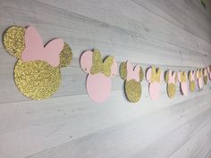 some pink and gold mickey mouse ears are hanging on the wall