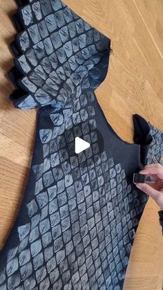 someone is cutting out an animal costume with scissors