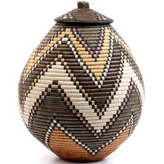 a woven basket with a lid is shown on a white background and has an interesting design