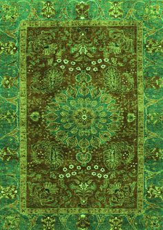 a green rug with an intricate design on the top and bottom, in different colors