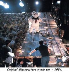 an inflatable ghost walking across a stage surrounded by people