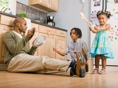 a man and two children playing with musical instruments