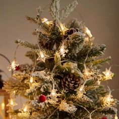 a small christmas tree with lights and decorations