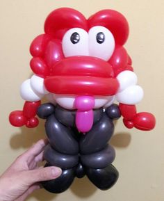 the balloon is shaped like a monkey with a pink tongue and nose on it's head