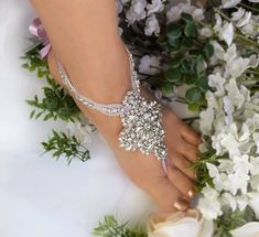 "-- Lavender Wedding Barefoot Sandals, Bridal Foot Jewelry, Silver Rhinestone Foot Jewelry, Footless Sandal- FT005 -- This stunning silver rhinestone footless sandal is the perfect accessory for a beach or garden wedding. This sandal is made clear rhinestone applique and silver satin ribbon. It is very comfortable and adjustable. Model in photo above is a US Size 7.5 . **This listing is for 1 PAIR (2 pcs) of barefoot sandals **Measurement** Applique Size: Approx 3.5\"L + 2.5 w Satin Tape : 3/8\" Wedding Barefoot Sandals With Rhinestones, Adjustable Rhinestone Barefoot Sandals For Wedding, Pearl Barefoot Sandals, Sandals Bridal, Lace Barefoot Sandals, Bridal Foot Jewelry, Beach Wedding Sandals, Beach Wedding Sandals Barefoot, Wedding Anklets