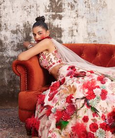 Editor's Note Featuring Varun Bahl's statement corsage lehenga set. It comes with a fully embroidered blouse and lehenga, accentuated with handmade floral corsages in tones of red and highlighted with feathers. It is paired with a detachable dupatta embellished with 3D floral detailings. Fabric: Organza, mono net Color: Pink Component: Lehenga, blouse and dupatta Occasion: Reception and sangeet Note: Product colour may slightly vary due to photographic lighting sources Care: Dry Clean Only About Elegant Floral Lehenga For Wedding, Wedding Festive Floral Choli, Wedding Festive Floral Embellished Sets, Pink Floral Lehenga For Wedding, Pink Floral Print Lehenga Unstitched, Pink Lehenga With Floral Embroidery, Pink Floral Organza Lehenga, Pink Floral Print Unstitched Lehenga, Pink Floral Embroidered Semi-stitched Lehenga