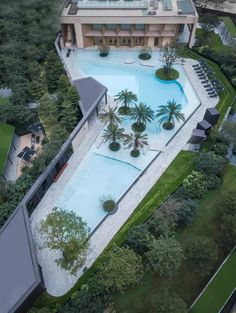 an aerial view of a large pool surrounded by trees