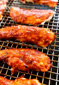 chicken wings are cooking on the grill