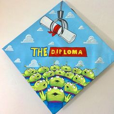 there is a blue and white kite with the words the diploma on it, surrounded by green cartoon characters