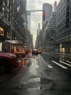 a city street filled with lots of traffic and tall buildings on either side of it