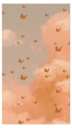 there are many small orange butterflies flying in the sky above some white clouds and pink clouds