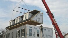 a house being lifted by a crane