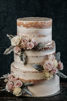 a three tiered cake with flowers on top