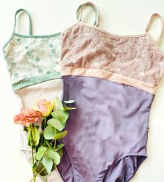 three women's bras with flowers on the bottom and one has a flower in it