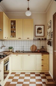 an image of a kitchen setting with checkered flooring on the floor and cabinets