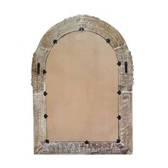 an old arched mirror with black studs on the bottom and sides, against a white background