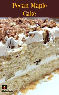 a piece of pecan maple cake with white frosting and walnuts on top