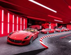 several red sports cars parked in an underground parking garage