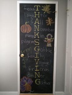 a chalkboard with words written on it in front of a door that says thanksgiving