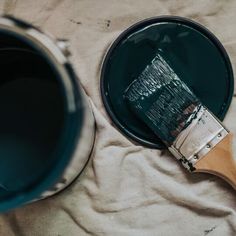 a paint can with a brush next to it