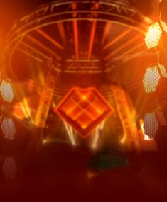 an abstract image of some lights in the dark and orange light from behind it,