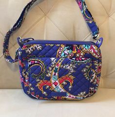 See more Vera Bradley handbags and accessories: Shop Savannah Lane All of our items are stored in a smoke free environment.They say "good things come in small packages" and this bag is no exception. A sized down version of the Carson Shoulder Bag. Lift the exterior snap flap to reveal one slip pocket, also includes a back exterior slip pocket for quick go-to grabs. Main interior compartment also features two slips and a zip pocket. 56" removable, adjustable strap. Zip top closure. Beautiful and Multicolor Rectangular Bag With Paisley Print, Everyday Use Bags With Paisley Print, Casual Multicolor Paisley Print Bags, Vera Bradley Handbags, Mini Shoulder Bag, Zip Top, Accessories Shop, Savannah, Savannah Chat