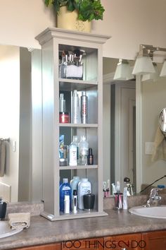 a bathroom with a sink, mirror and shelving unit filled with personal care products