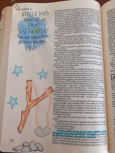 an open book with drawings on the pages and words written in spanish, english and french