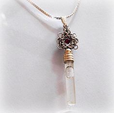 A sterling silver Romanov flower  handwoven adorned with a genuine gemstone bead is the crown to the glass vial pendant.   The clear mini glass Vial are filled with one of the Biblical essence such as Holy water from the Jordan River in the Holy Land,  Anointment oil from olive trees of Jerusalem, Terra Santa from Bethlehem, or frankincense from Jerusalem. The vial is permanently sealed and comes with a certificate of authenticity. Each pendant has a RAQUEL trade mark tag and comes in a gift box Silver Glass Flower Pendant Jewelry, Unique Silver Jewelry For Personal Use, Clear Glass Jewelry For Healing, Clear Glass Healing Jewelry, Elegant Glass Jewelry For Healing, Spiritual Silver Glass Jewelry, The Jordan River, Jordan River, Terra Santa