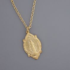 "Vintage Jewelry - Vintage Necklace - Gold Brass Mother Mary Necklace - Catholic jewelry - Chloe's Vintage Jewelry - Spiritual Jewelry - handmade jewelry This is such a beautiful vintage necklace!  Vintage gold brass with a highly detailed image of Mother Mary on the front and the heart of Mary and Jesus on the back.  Exquisite detail. The pendant hangs from a gold plated chain.  Chloe says, Wear it and feel fabulous!\" The pendant is 1 1/4\" long.  You can choose the necklace length you would l Miraculous Medal Pendant Necklace For Anniversary, Anniversary Pendant Necklace With Miraculous Medal, Mother Mary Necklace, Vintage Chloe, Jewelry Spiritual, Aquarius Necklace, Mother Mary Images, Mary Necklace, Heart Of Mary