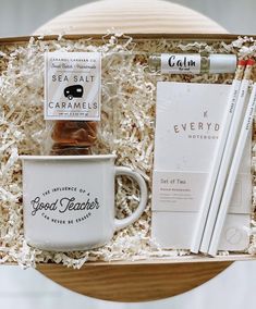 a coffee cup, pencils, and notepad in a gift box