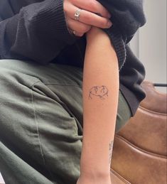 a person with a small tattoo on their arm