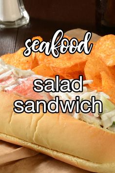 a sandwich with potato chips on it and the words seafood salad sandwich written in white